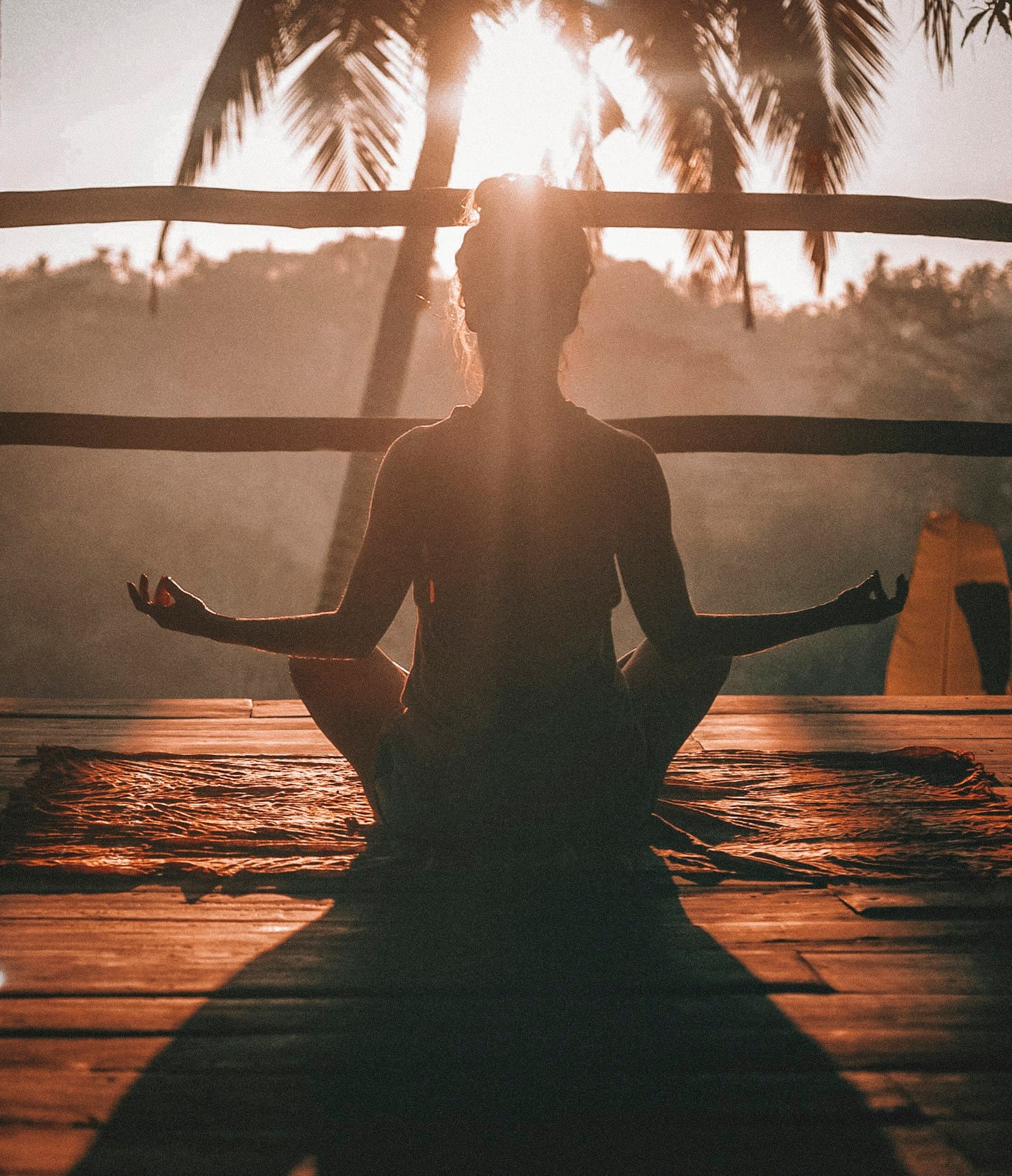 A person practising breathing and stretching on a wooden floor