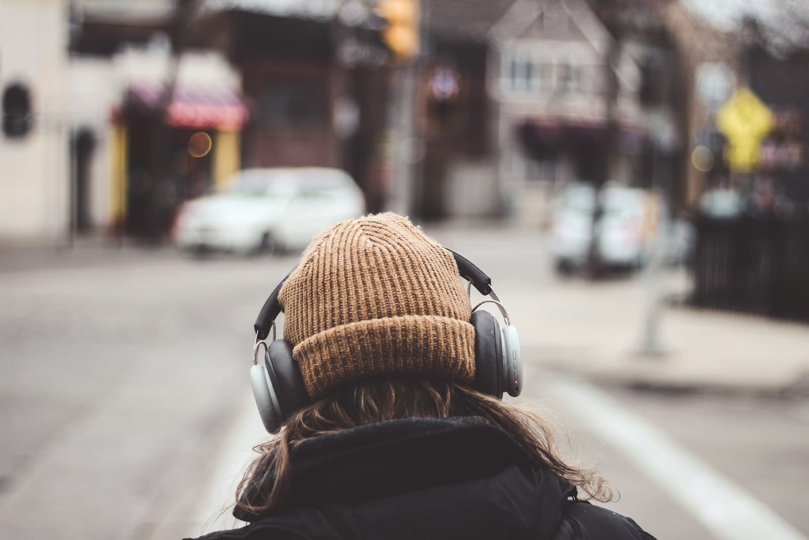 A person wearing headphones, absorbed in the music
