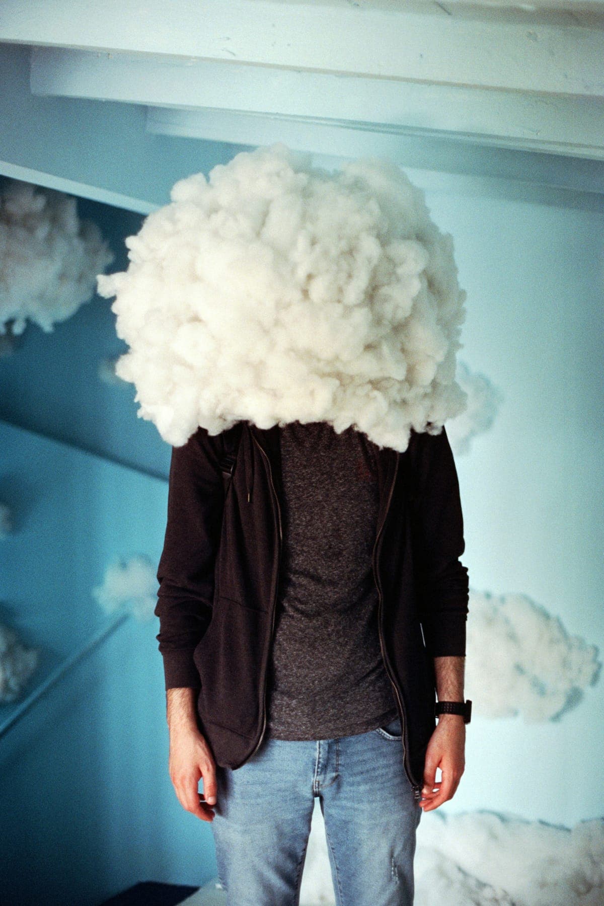 A person standing calmly with a soft cloud where their head would be